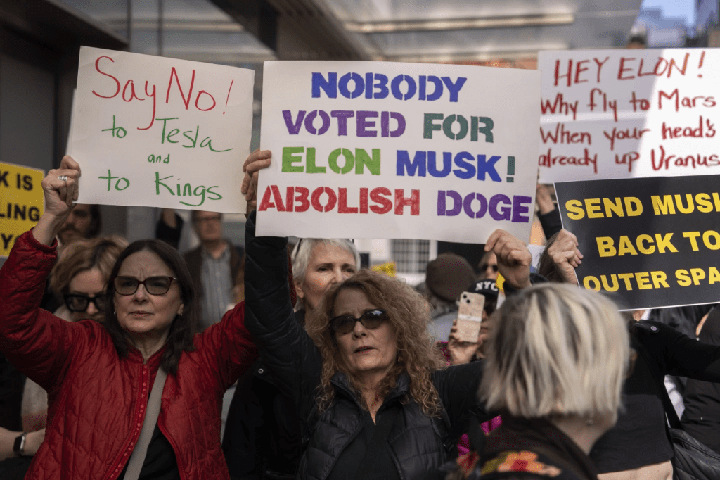 Anti-DOGE Protests Erupt at Tesla Stores, Challenging Elon Musk’s Financial&nbsp;Interests
